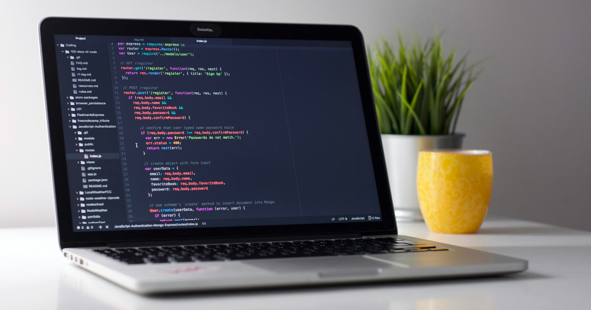 은색 노트북 화면에 Express.js 인증 라우트 코드가 열려 있음