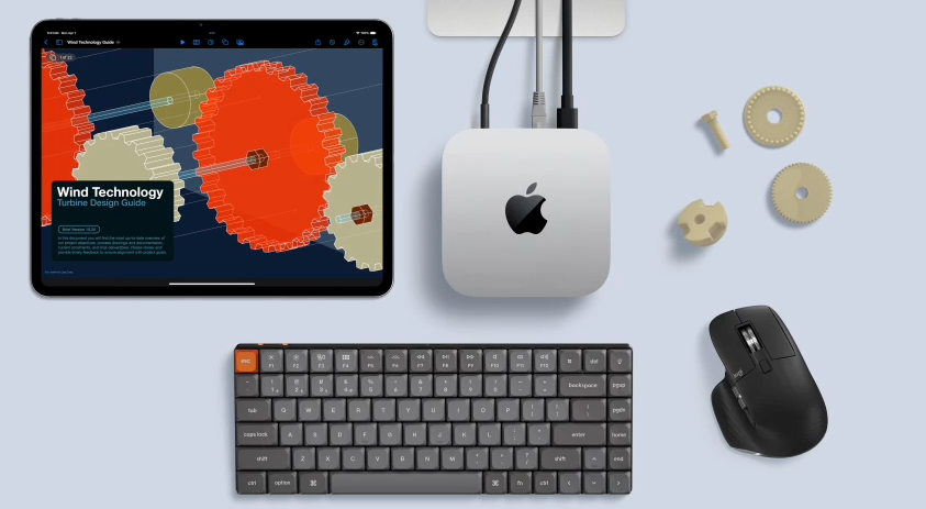 Mac mini and iPad Pro engineering workstation with mechanical keyboard, ergonomic mouse, and 3D part model